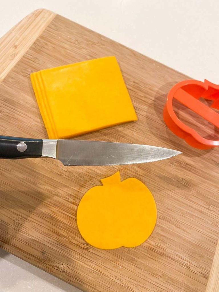 sharp knife with pumpkin cheese cut out