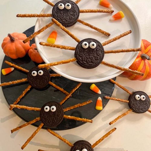 finishes spider cookies on a tray
