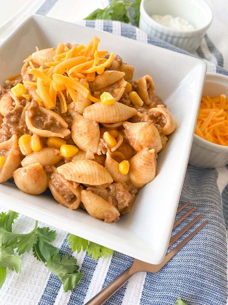taco pasta in a bowl with cheese on top