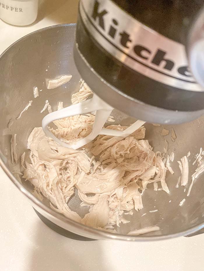 shredded chicken in mixing bowl