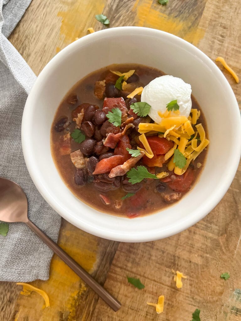 Easy Black Bean Soup with spoon and toppings