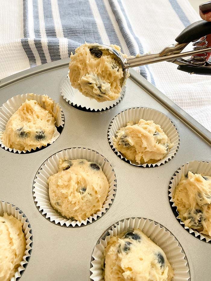 scooping batter into muffin liners