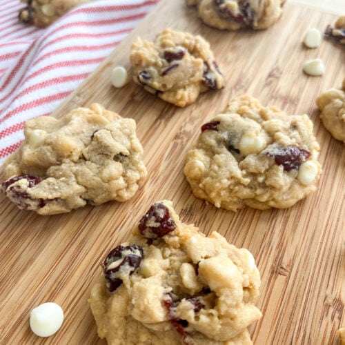 white chocolate cherry cookies on wooden tray with white chocolate chips