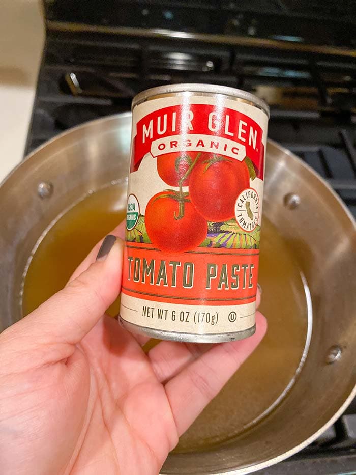 Add tomato paste to broth