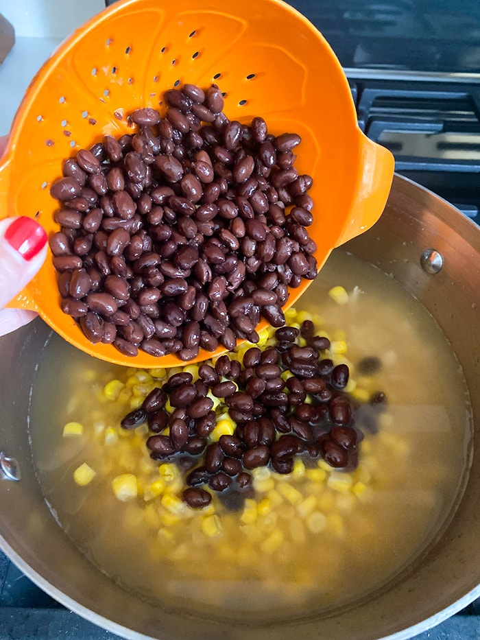 adding beans to pot