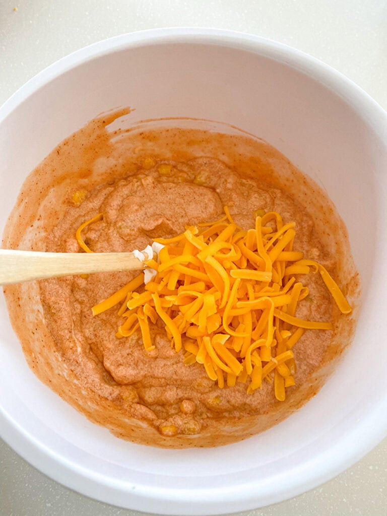 stirring cheese into sauce