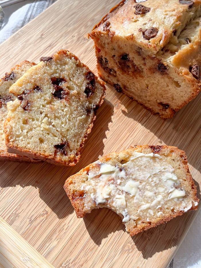 banana bread with chocolate chips sliced with butter
