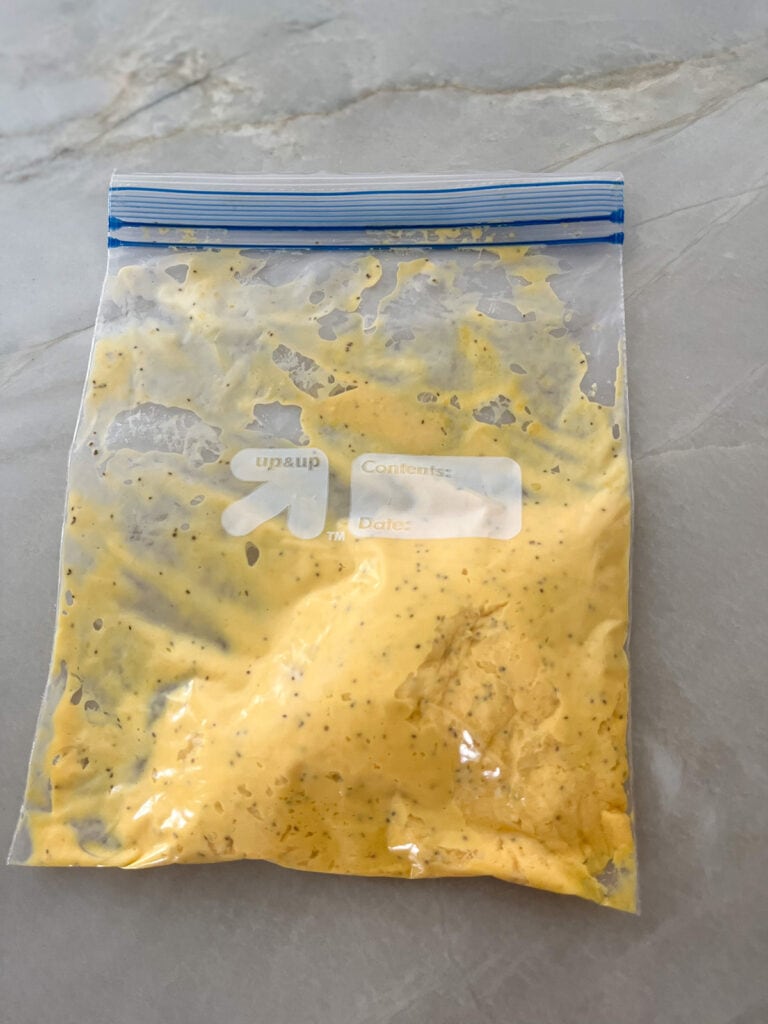 slide yolk mixture to one corner of baggie