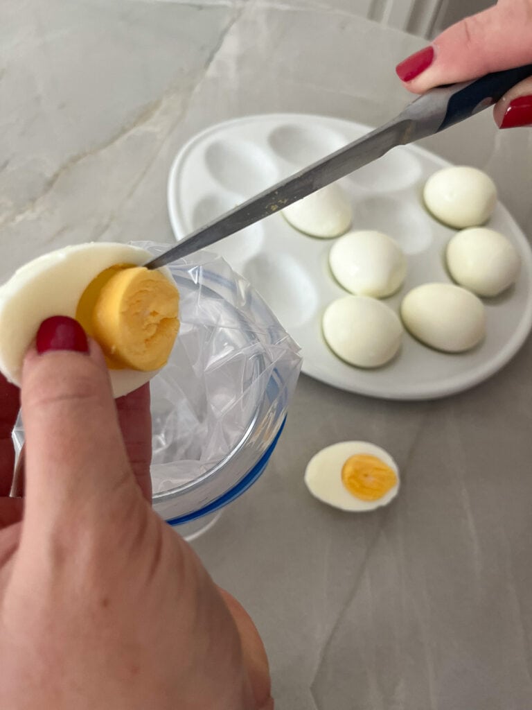 remove yolks and drop them in baggie over glass