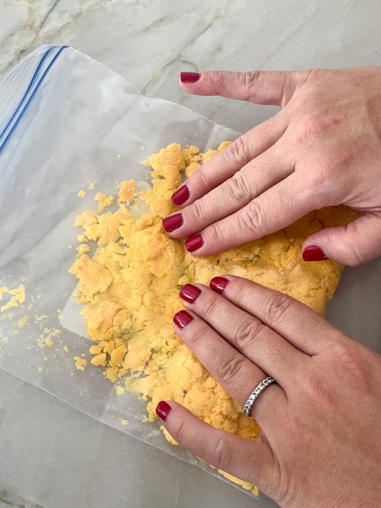 smash egg yolks in baggie with fingers