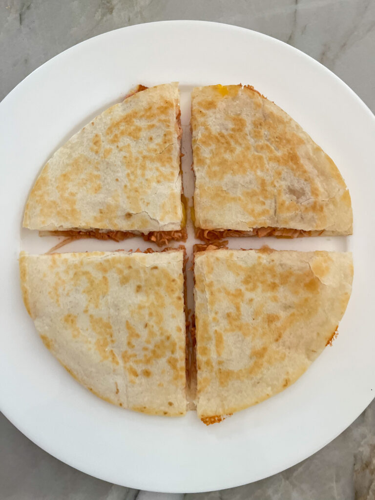 cut BBQ Chicken Quesadilla with Pineapple into 4 equal pieces