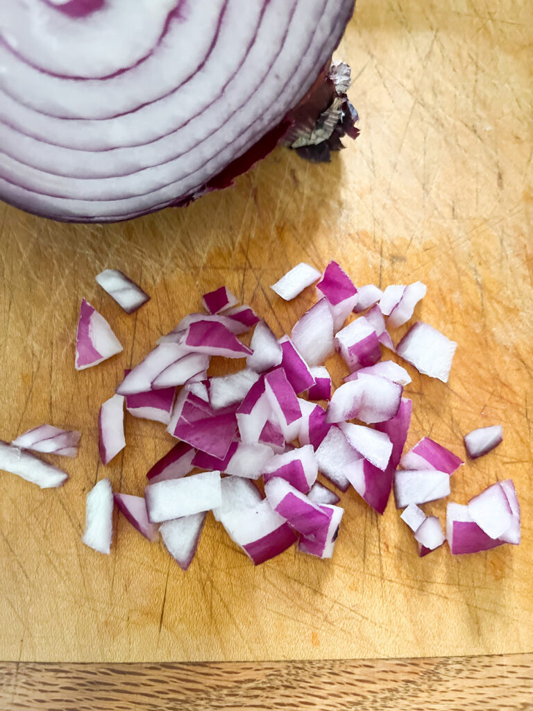 diced red onion on cutting board