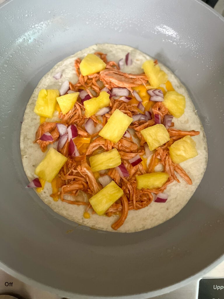 layer pineapple and red on to onto quesadilla