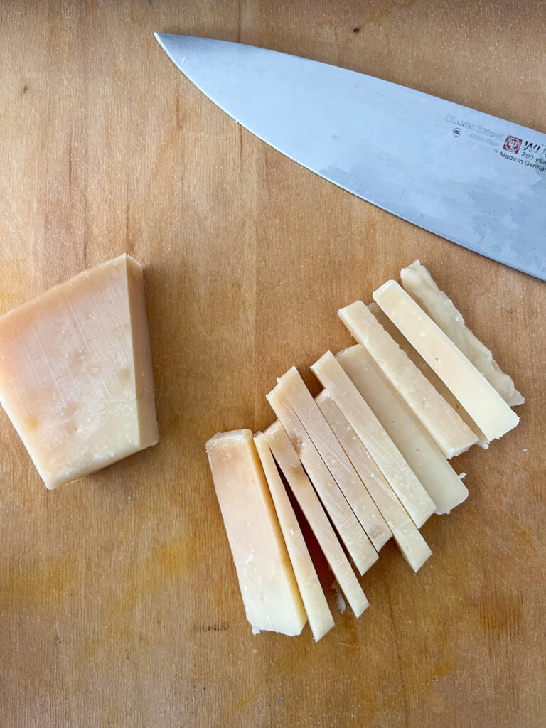 chop parmesan cheese into strips or large chunks