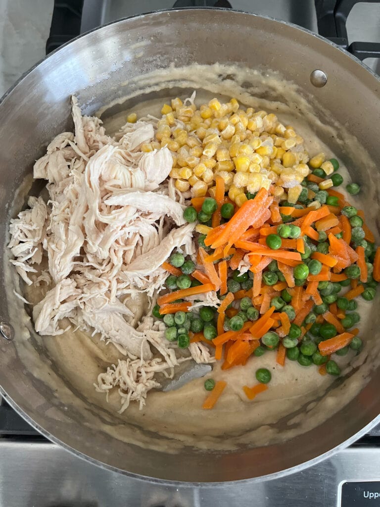 add chicken and frozen vegetables to pan