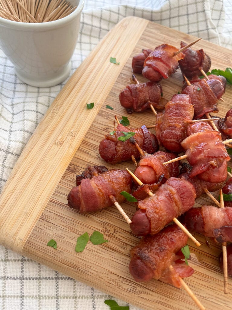 a pile of Bacon Wrapped Little Smokies on wood tray