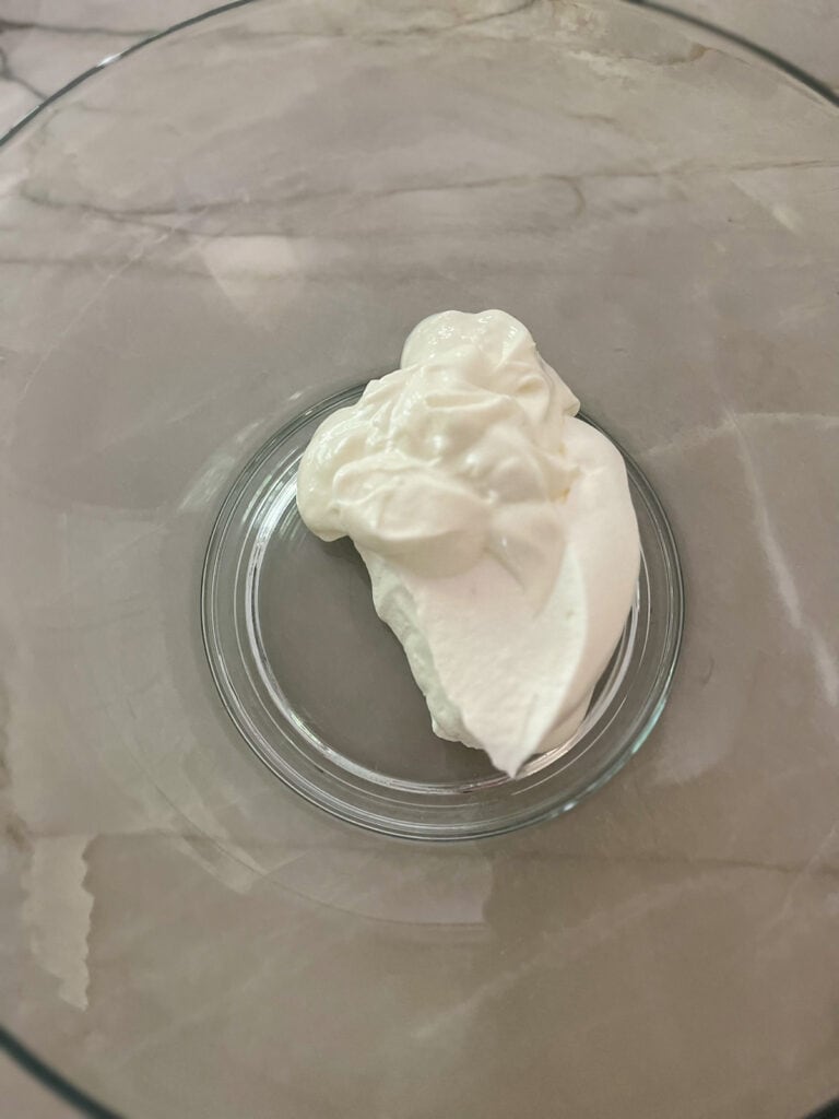 whipped cream and yogurt in large glass bowl