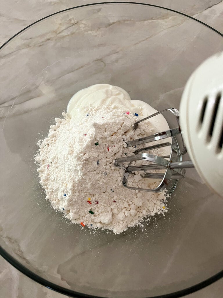hand mixer with Funfetti Cake Dip ingredients in large bowl
