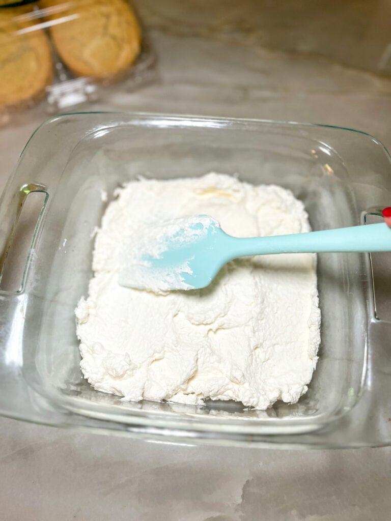 spread whipped cream in 8x8 baking dish