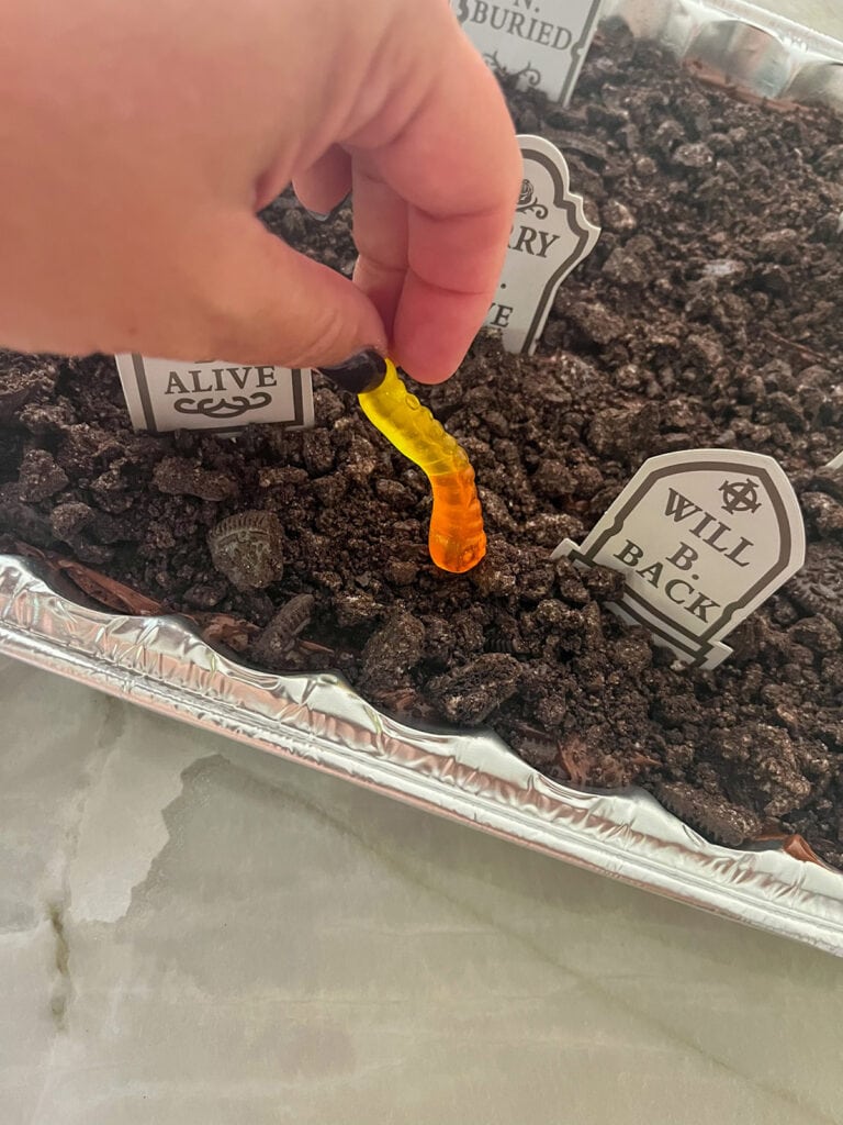 place gummy worms on(Halloween) Graveyard Brownies