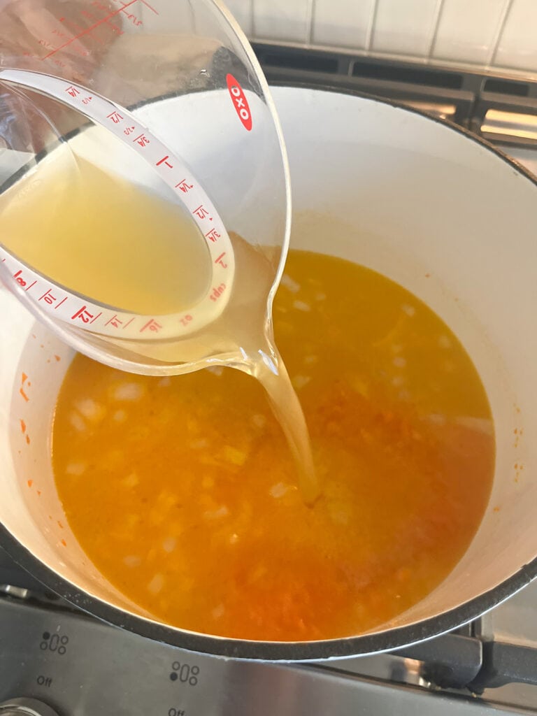 adding chicken broth to duchy oven for Broccoli Cheese Soup