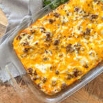 cooked Breakfast Casserole with Cream Cheese and Crescent Rolls on a wood table with a grey napkin