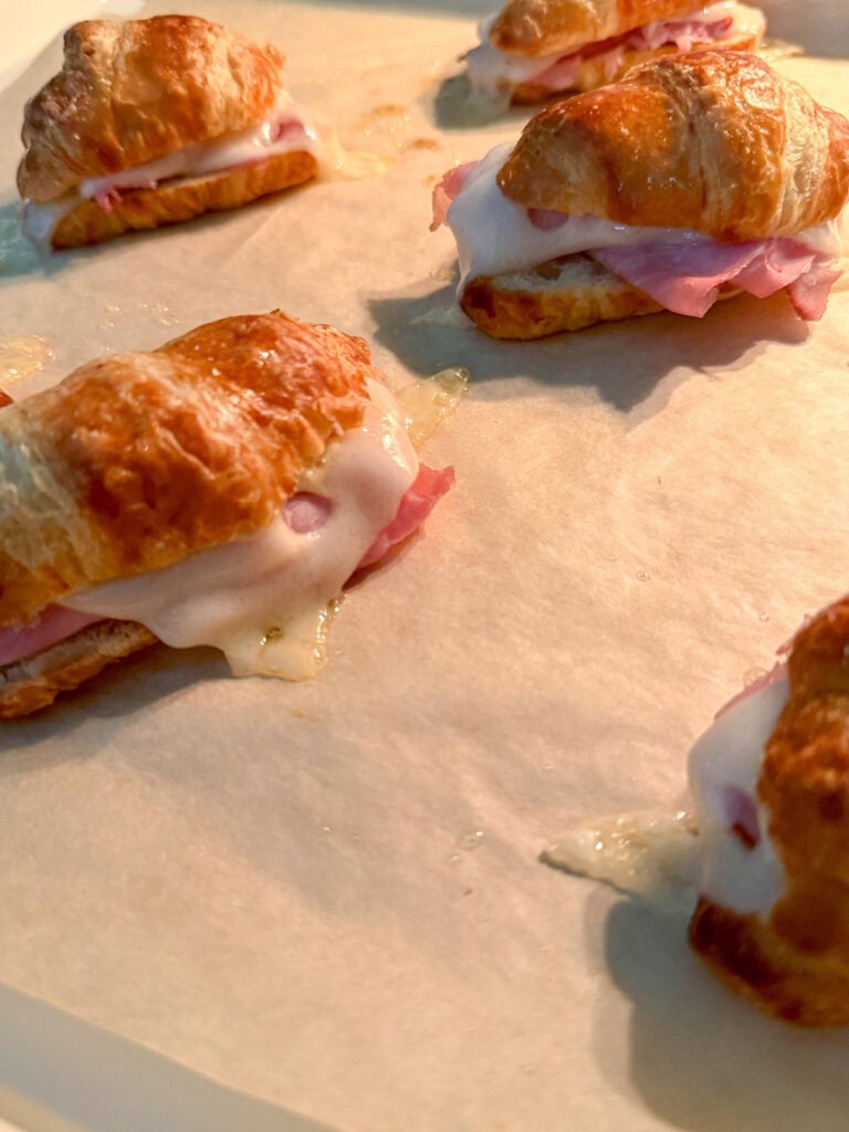 baked Mini Ham and Cheese Croissant Sandwiches on baking sheet