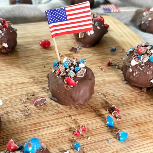Patriotic Peanut Butter Bon Bons on a wood serving tray with a grey napkin background