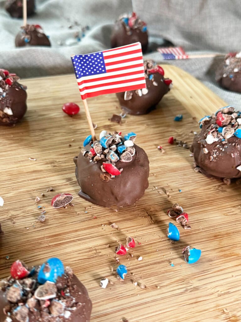 Patriotic Peanut Butter Bon Bons on a wood serving tray with a grey napkin background