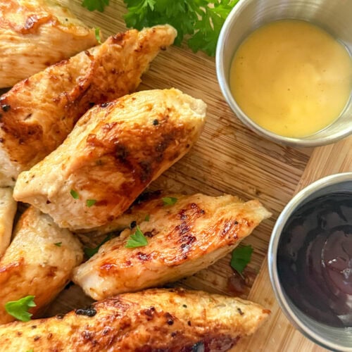 Cracker Barrel Grilled Chicken Tenders on wood tray with dipping sauces