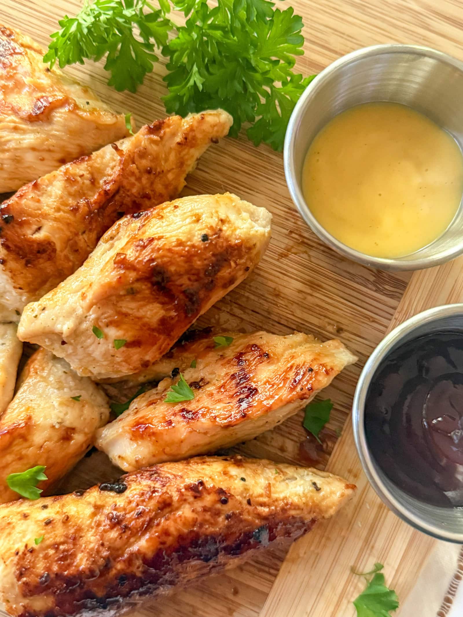 Cracker Barrel Grilled Chicken Tenders on wood tray with dipping sauces
