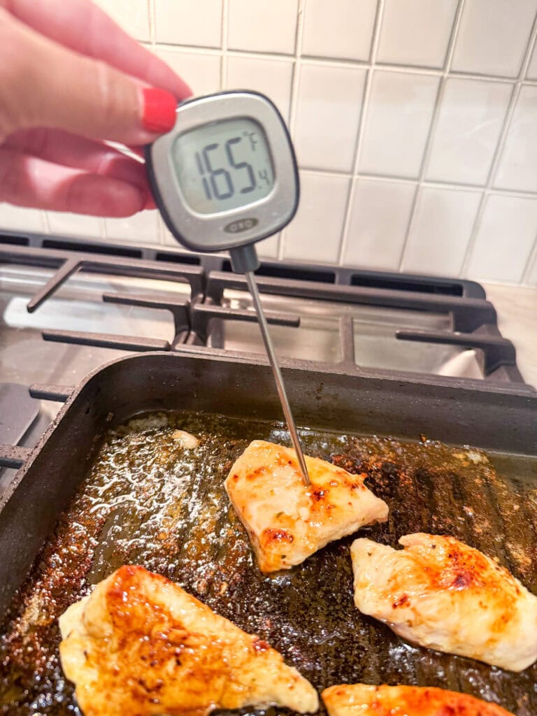 Cracker Barrel Grilled Chicken Tenders in a pan with a meat thermometer showing 165 degrees