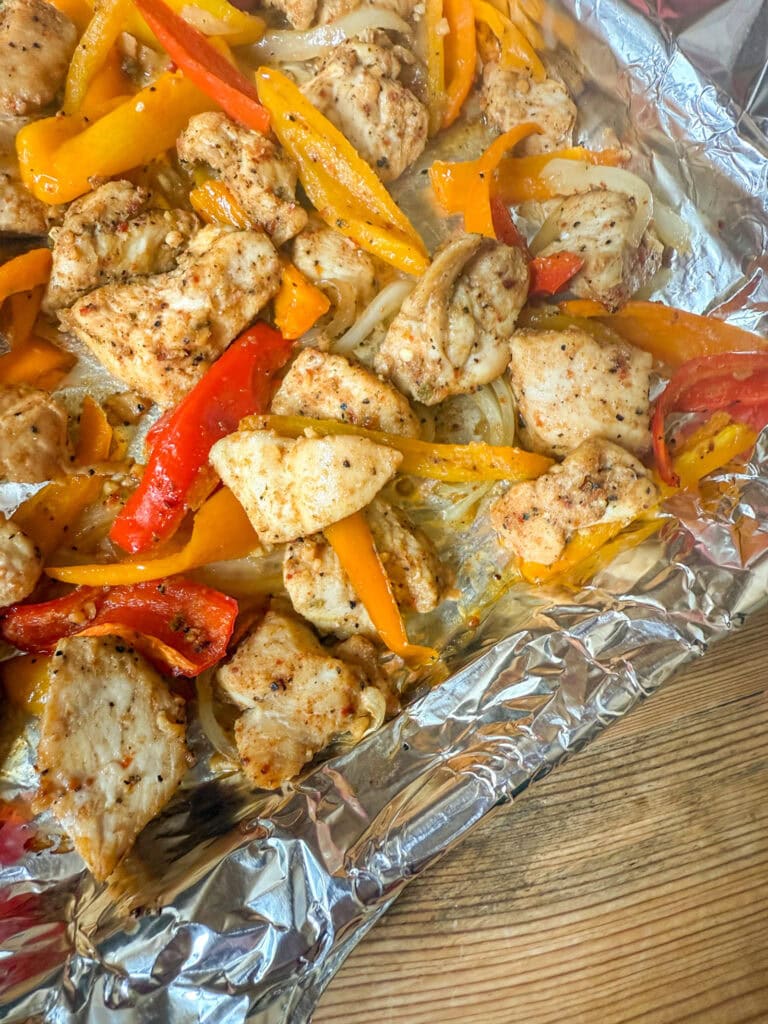 cooked Sheet Pan Fajitas on an foil lined baking sheet ready to serve