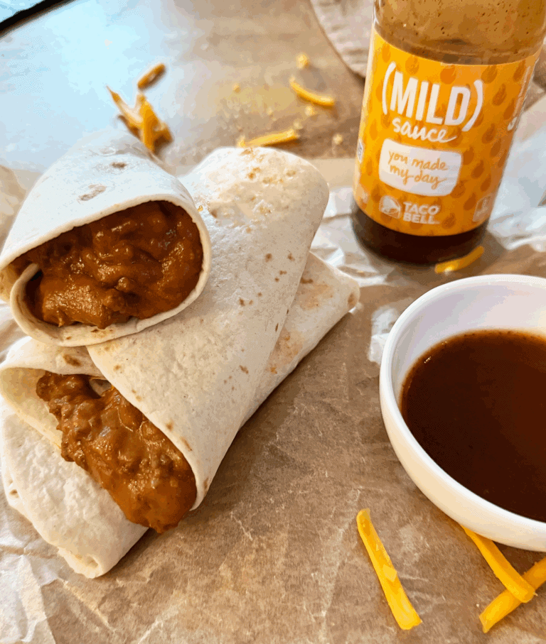 a stack of Copy Cat Taco Bell Chili Cheese Burritos with mild sauce in background