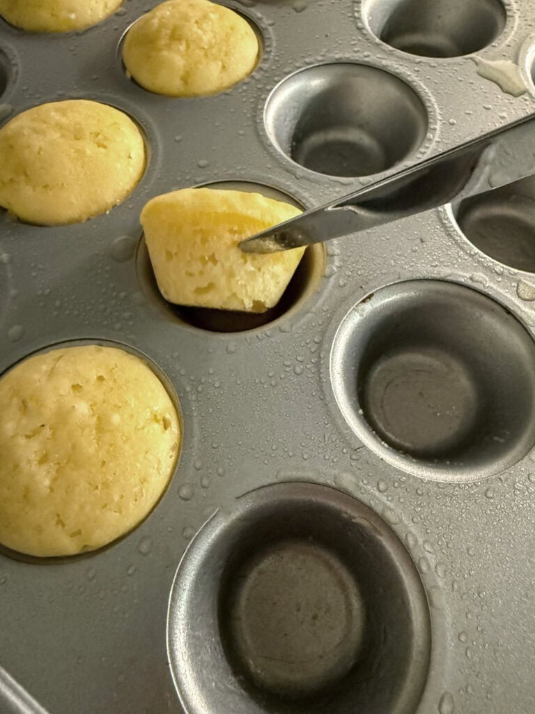taking baked pancake bites out of muffin tin
