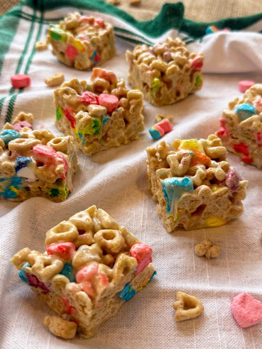 Lucky Charms Cereal Bars cut into squares on a white and green napkin ready to serve at a party