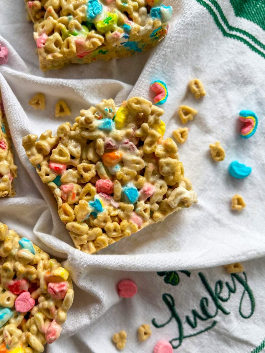 Lucky Charms Cereal Bars cut into large squares on a white and green napkin that says "lucky"