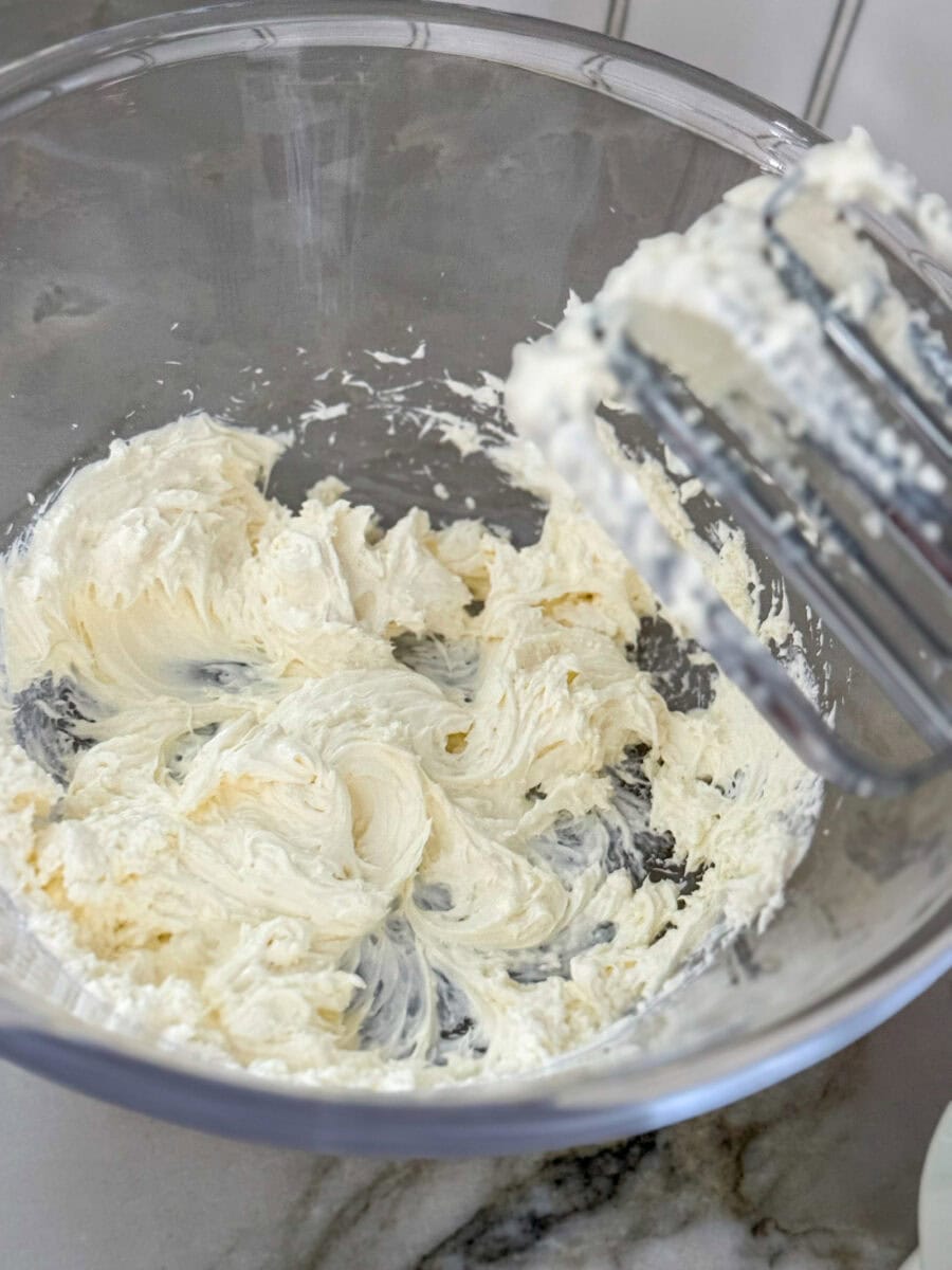 whipped cream cheese in a glass mixing bowl