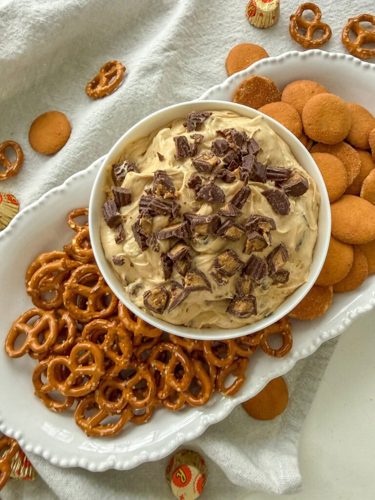 Reese's Peanut Butter Cup Dip on a white platter with Nilla Wafers and pretzels for dipping