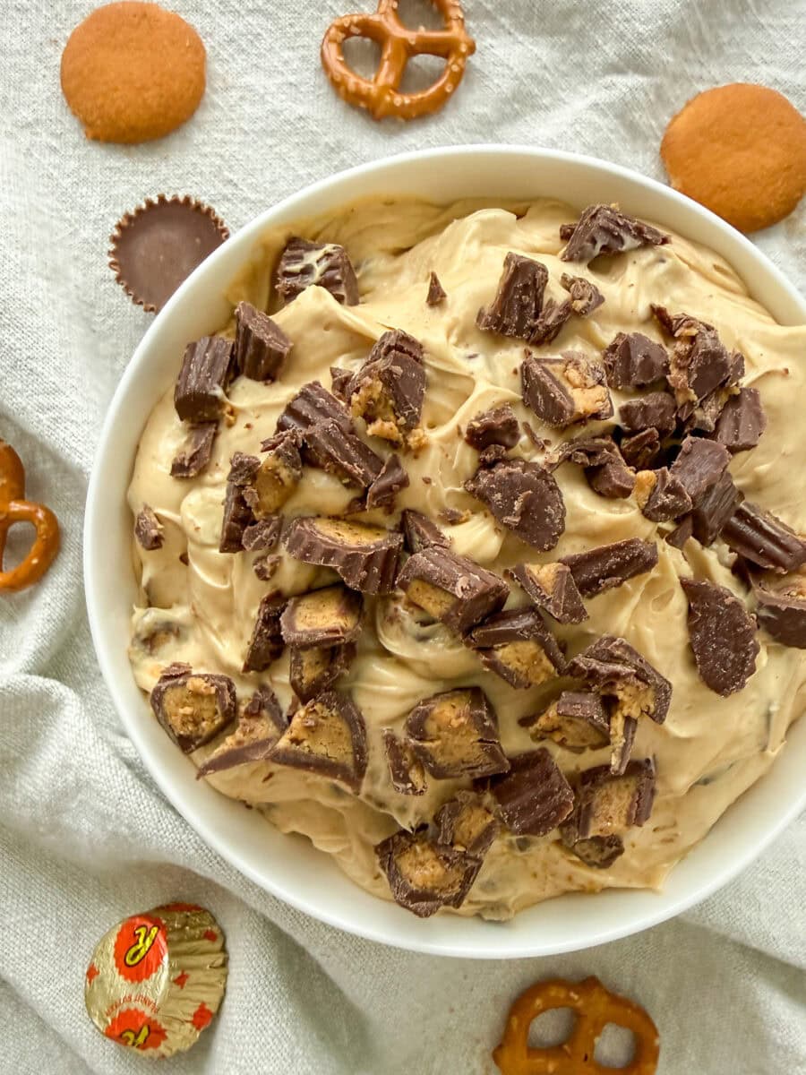 Reese's Peanut Butter Cup Dip in a white bowl on a light grey napkin 