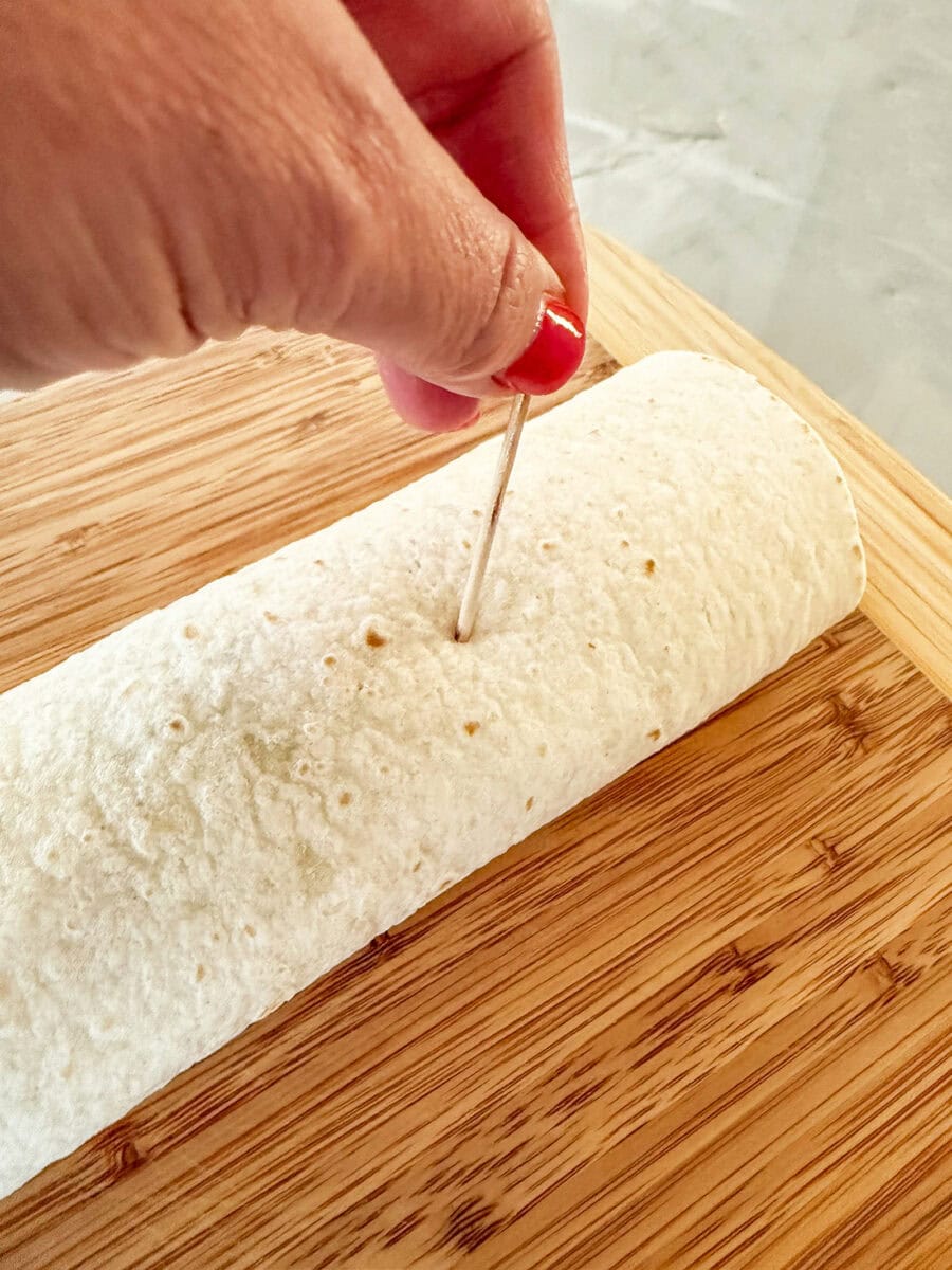 putting toothpicks into wrap