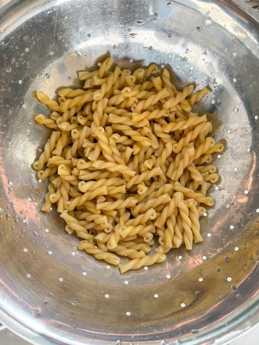 cooked gemelli pasta in colander
