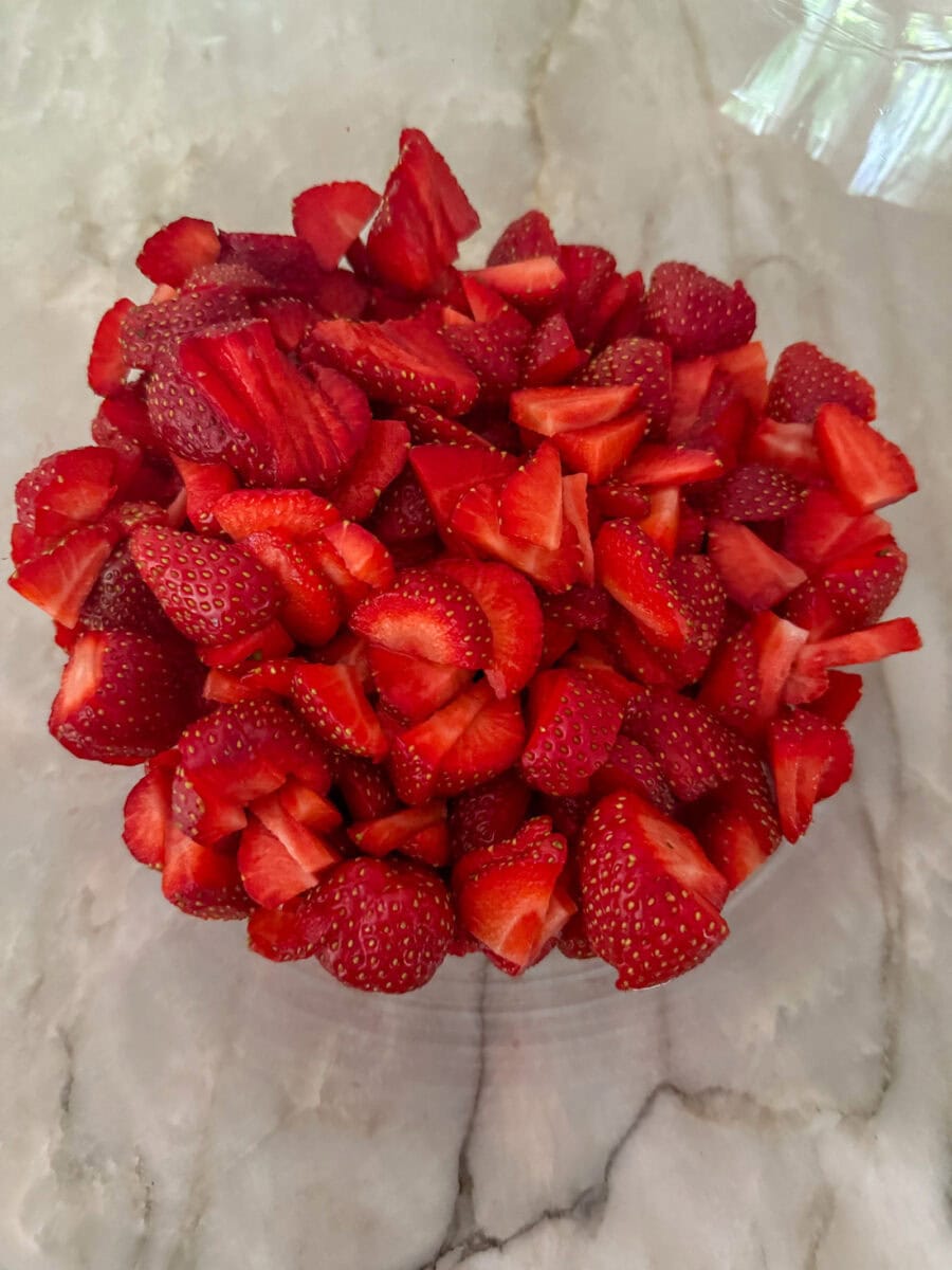 washed and chopped strawberries in a bowl
