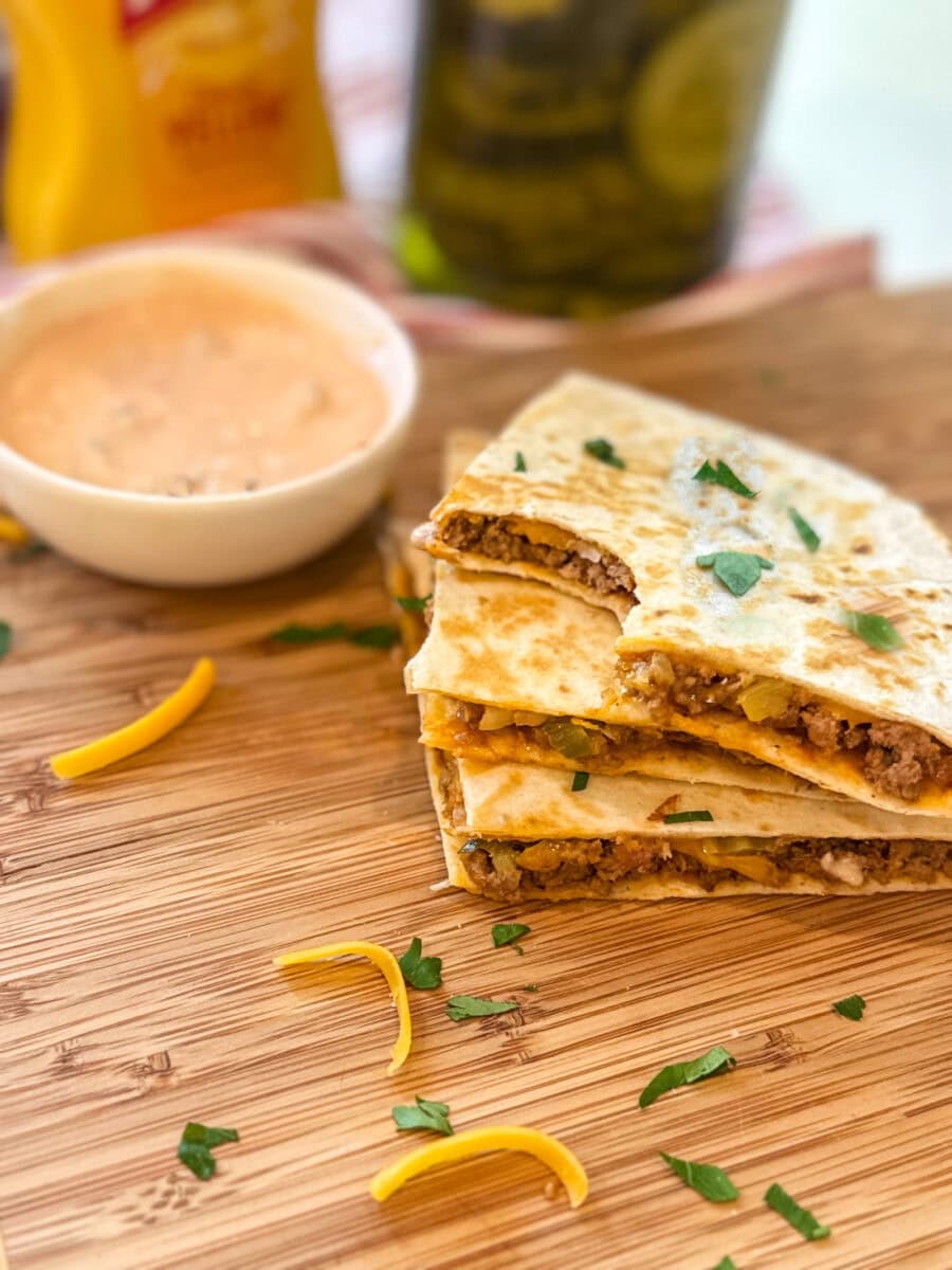 Cheeseburger Quesadillas on a wood tray with dipping sauce