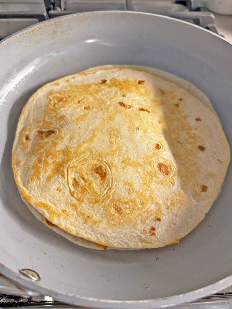 cooked quesadilla in fry pan
