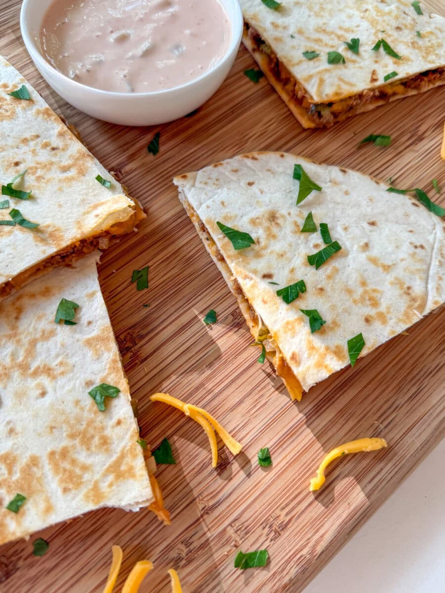 Cheeseburger Quesadillas on a wood tray with dipping sauce