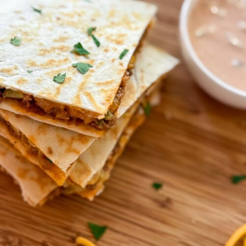Cheeseburger Quesadillas on a wood tray with dipping sauce
