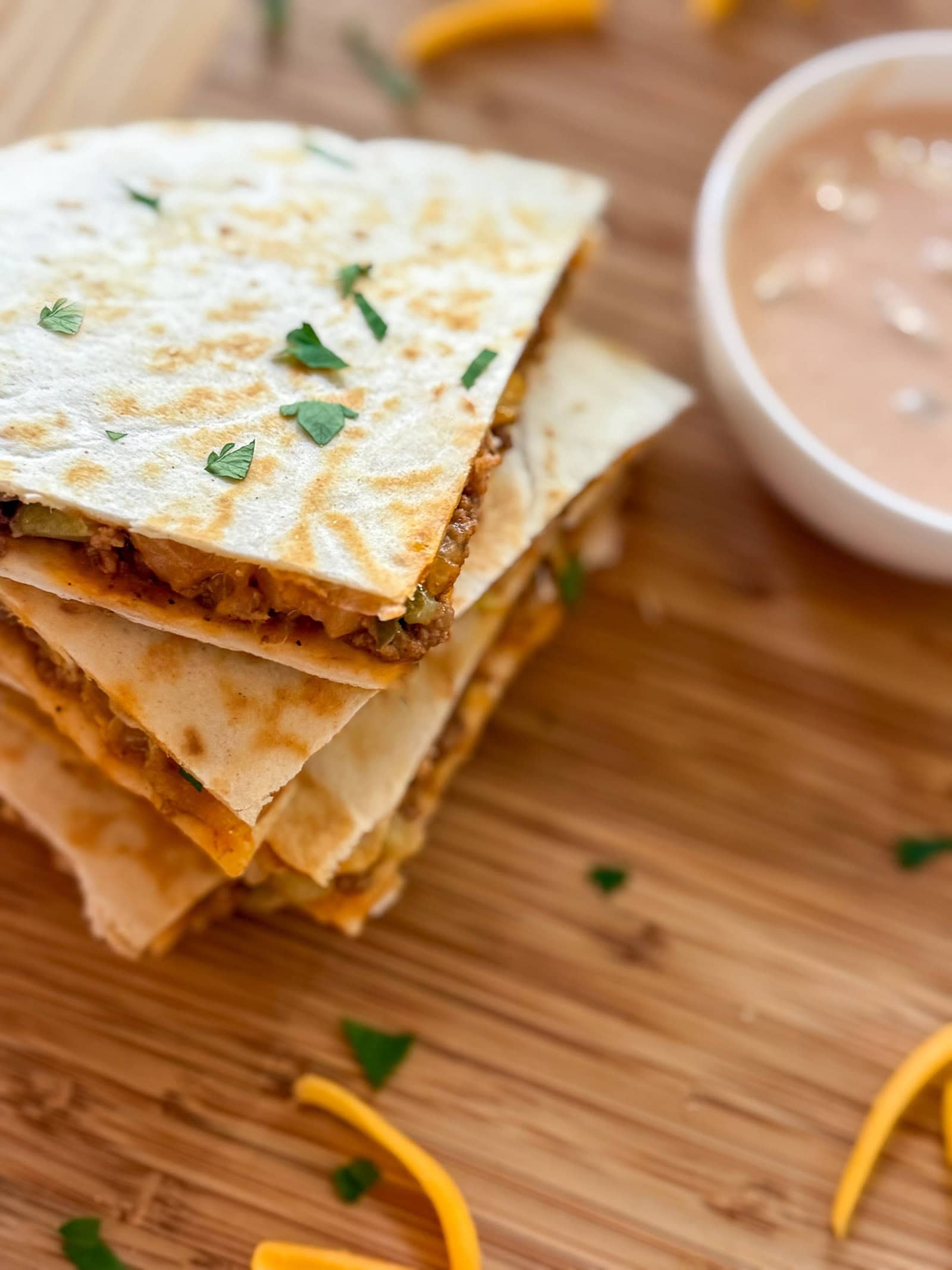 Cheeseburger Quesadillas on a wood tray with dipping sauce