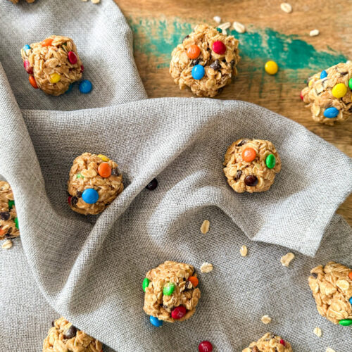 Monster Cookie Protein Balls on wood table with grey napkin
